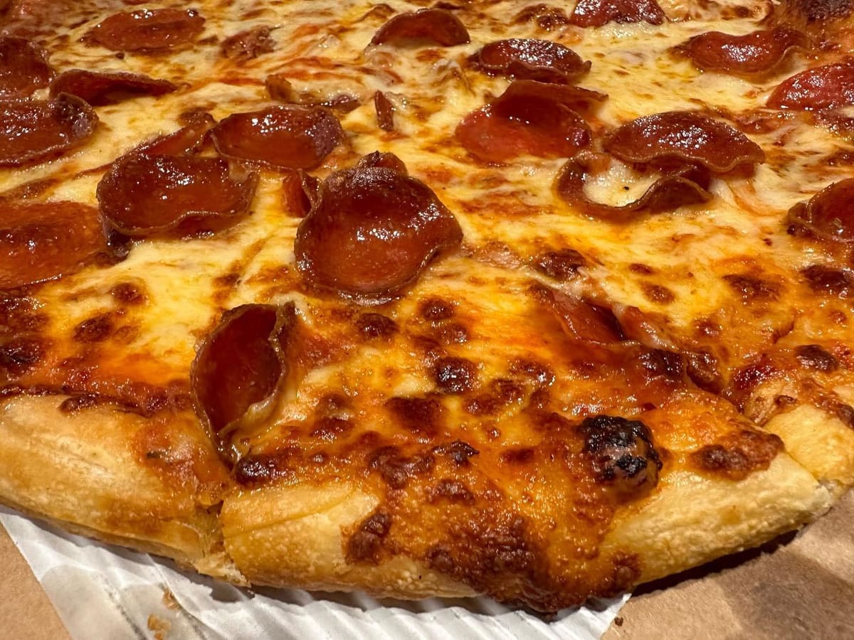 Close view of a pizza slice at Mio’s Pizzeria