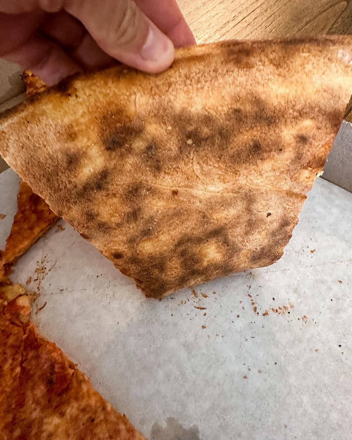 Underside of the pizza crust at Naples Pizza & Restaurant