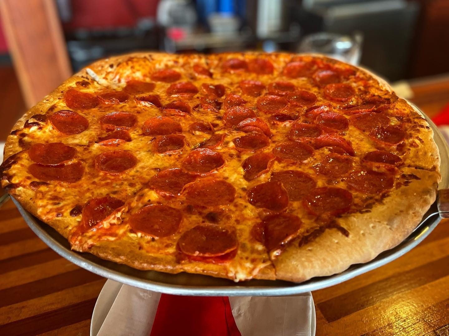 The whole pie on a stand at Newport Pizza Company