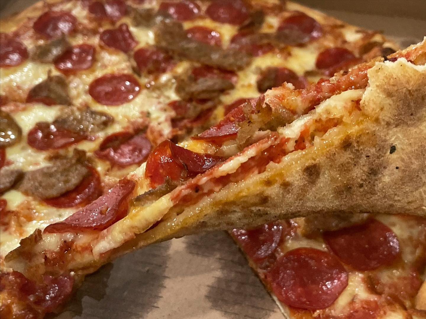 A slice lifted from the pie at Noce’s Pizzeria