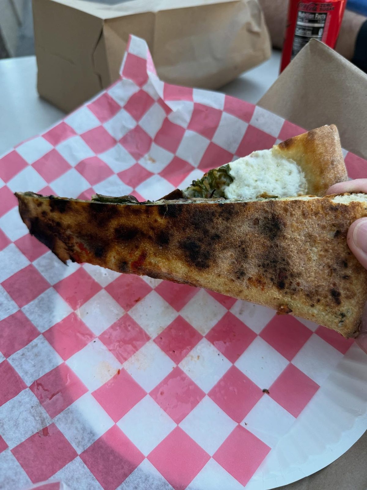 Underside of the thin crust with restrained charring at Norm’s Pizza