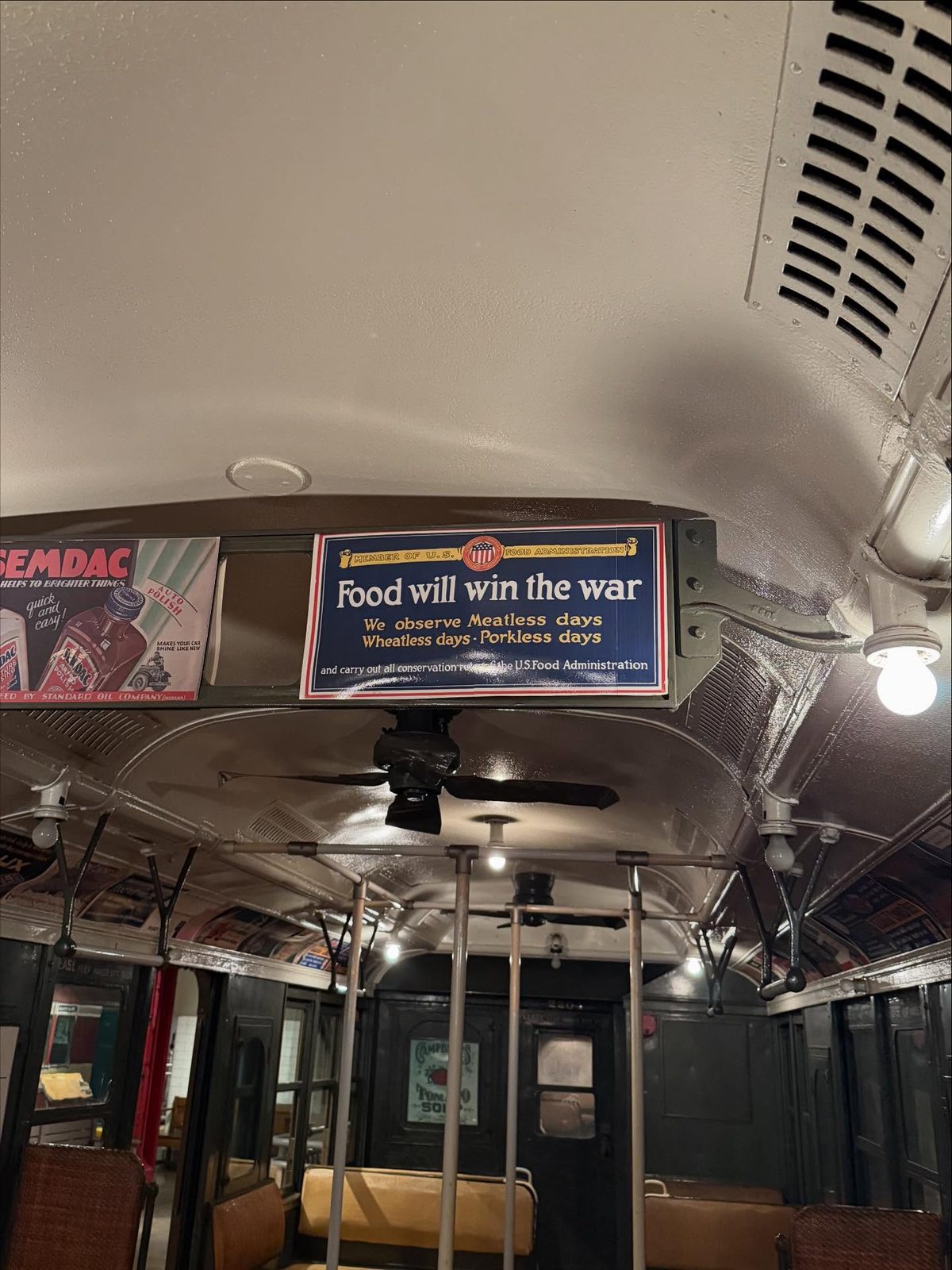 Interior of a vintage subway car at the New York Transit Museum, across from Norm’s Pizza