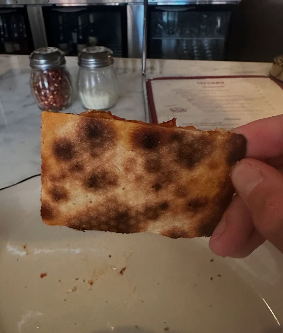 Underside of the pizza crust at Pizz’Amici