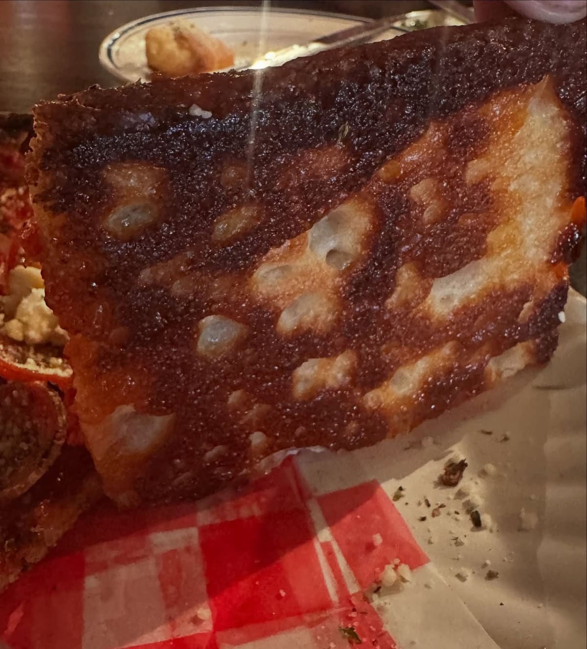 Underside of the pizza crust at Professor Pizza