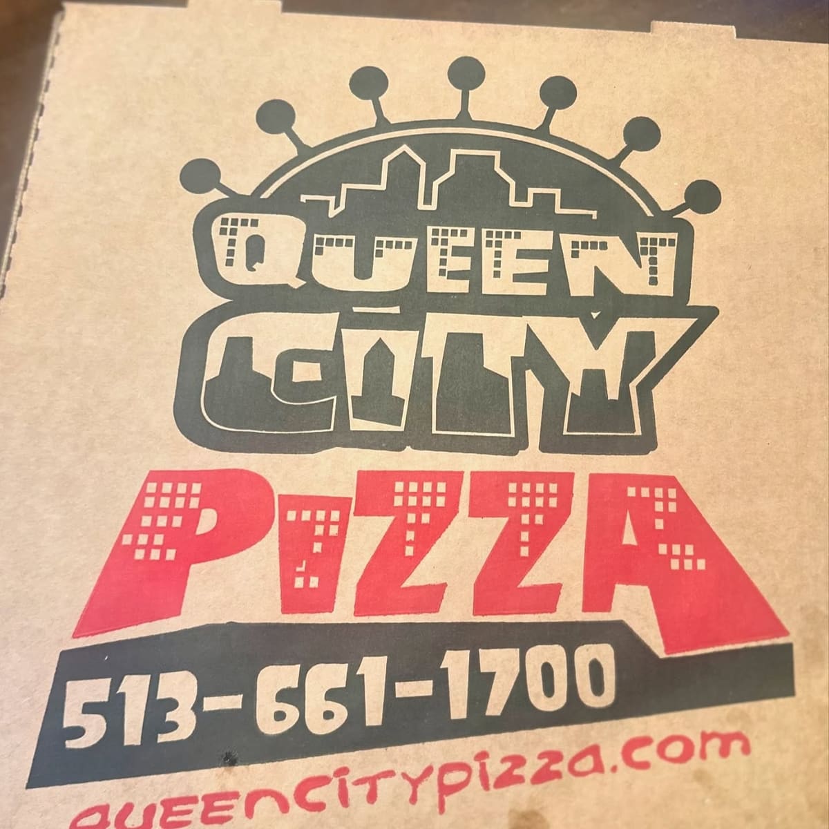 Restaurant sign at Queen City Pizza