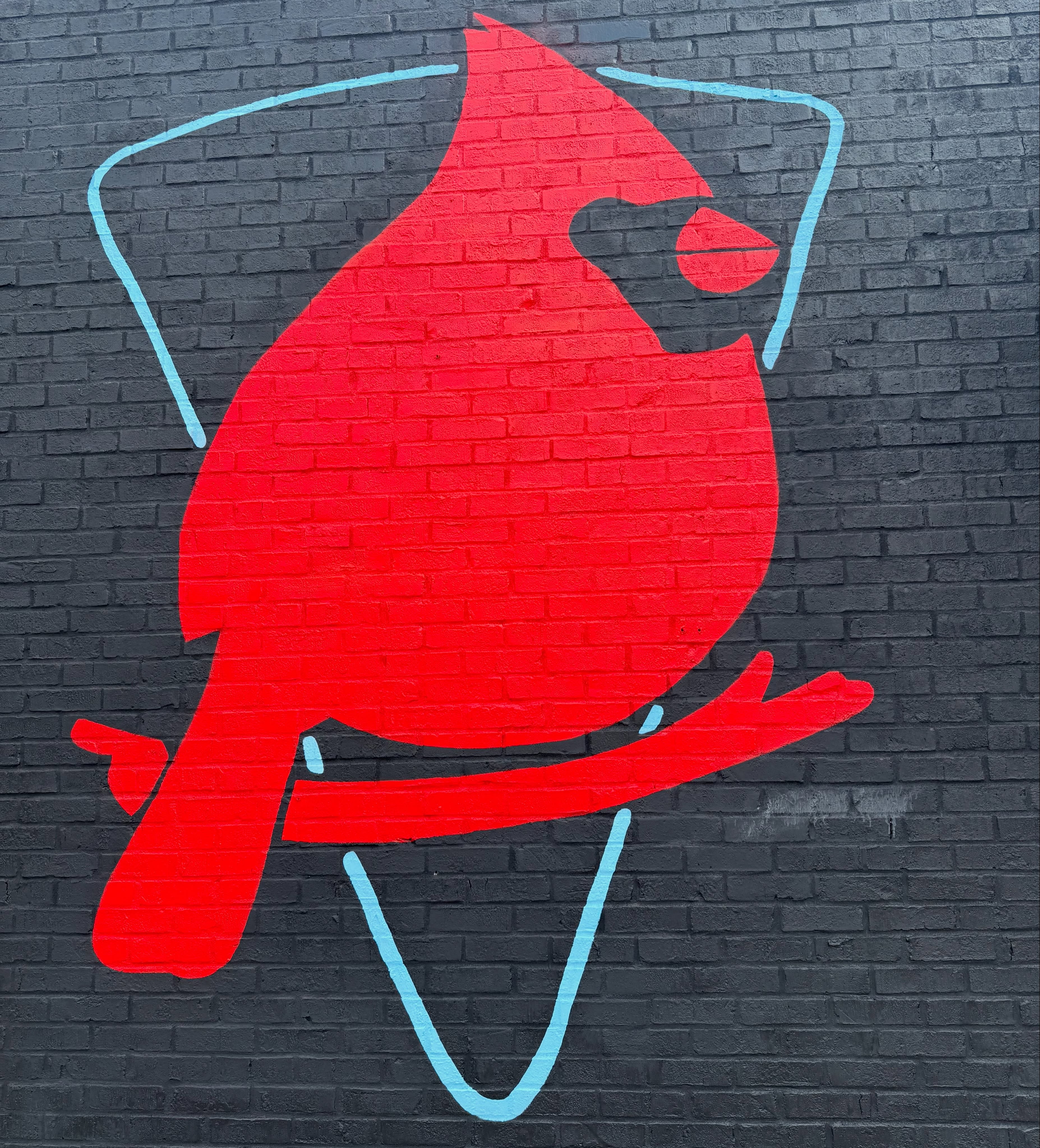 Red cardinal mural painted on the exterior brick wall, Red Bird Pizza