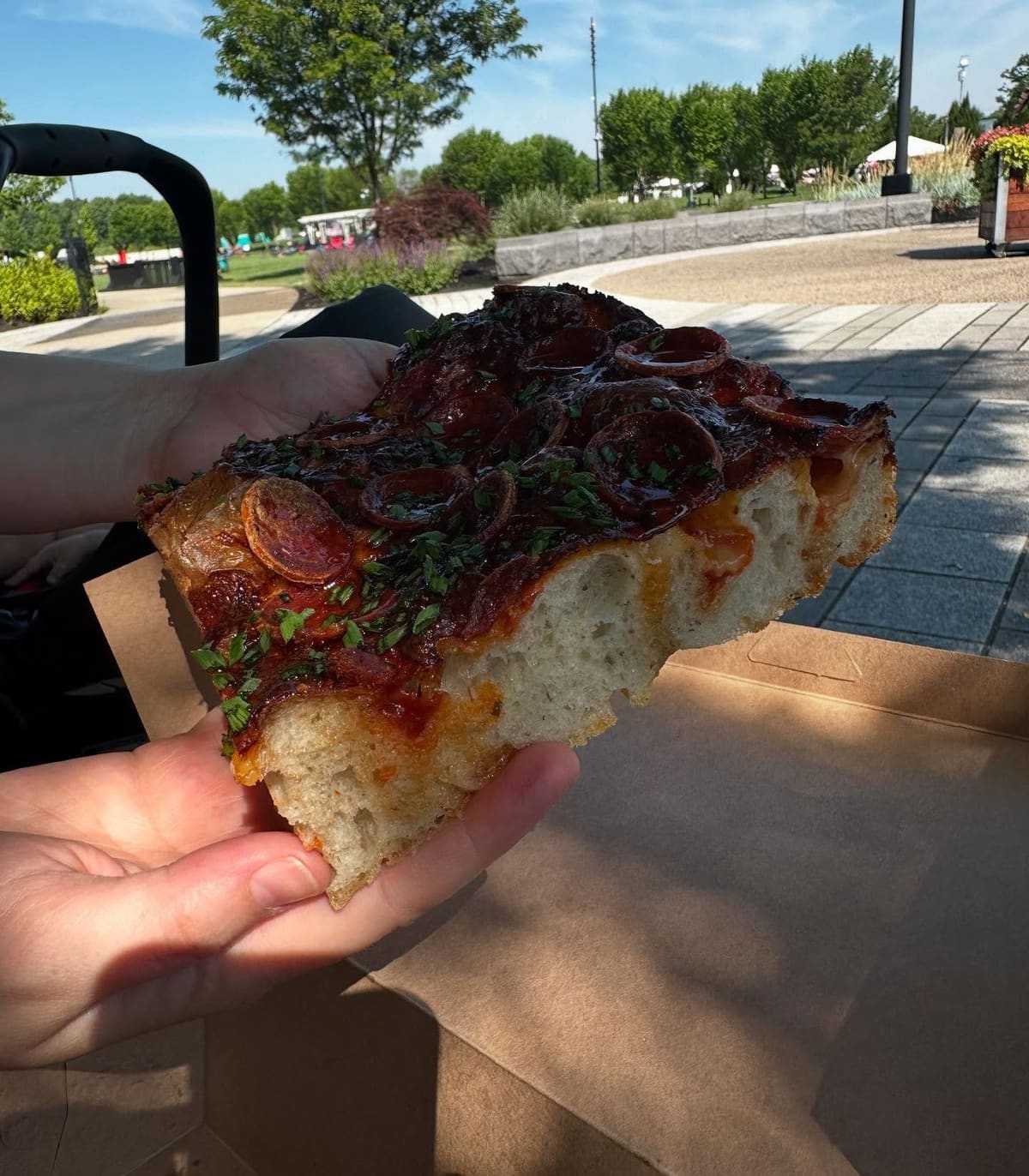 Pizza slice held up for a closer view at Sebastian Bakehouse