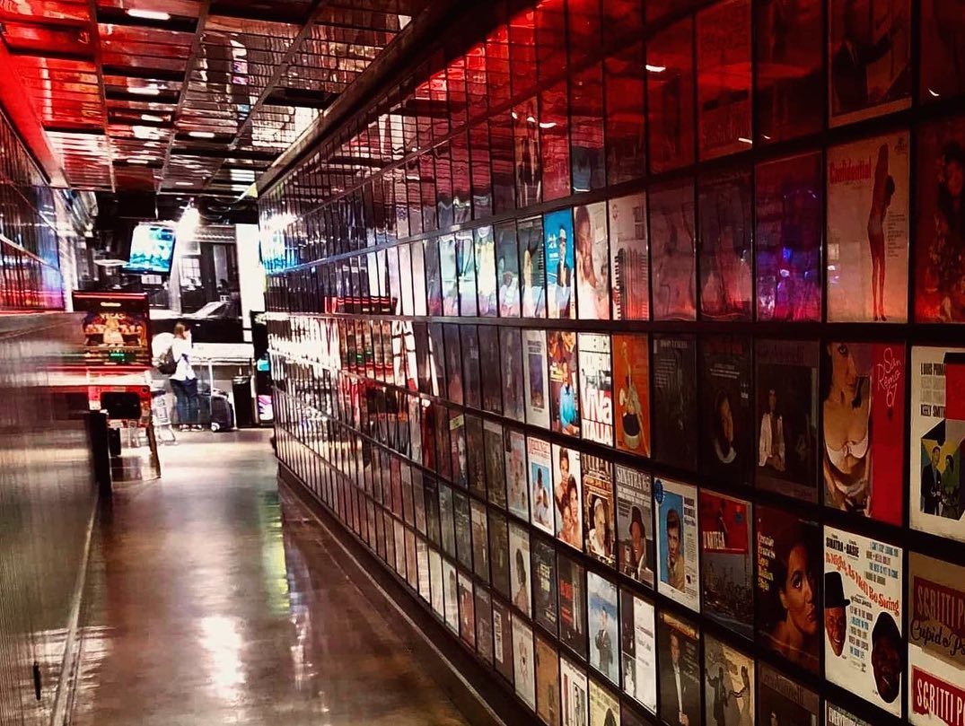 Hallway lined with record album covers at Secret Pizza