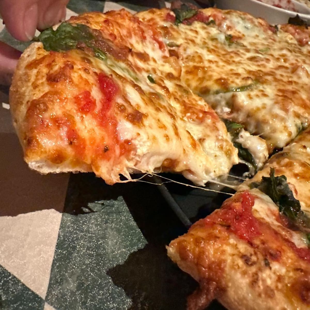 Pizza slice being lifted at Sorrento’s