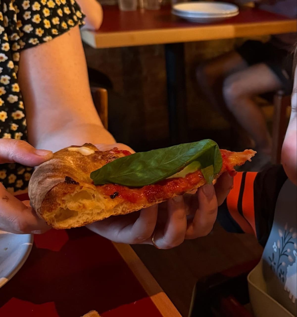 Pizza slice held up for a closer view at St Francis Apizza in Oakley
