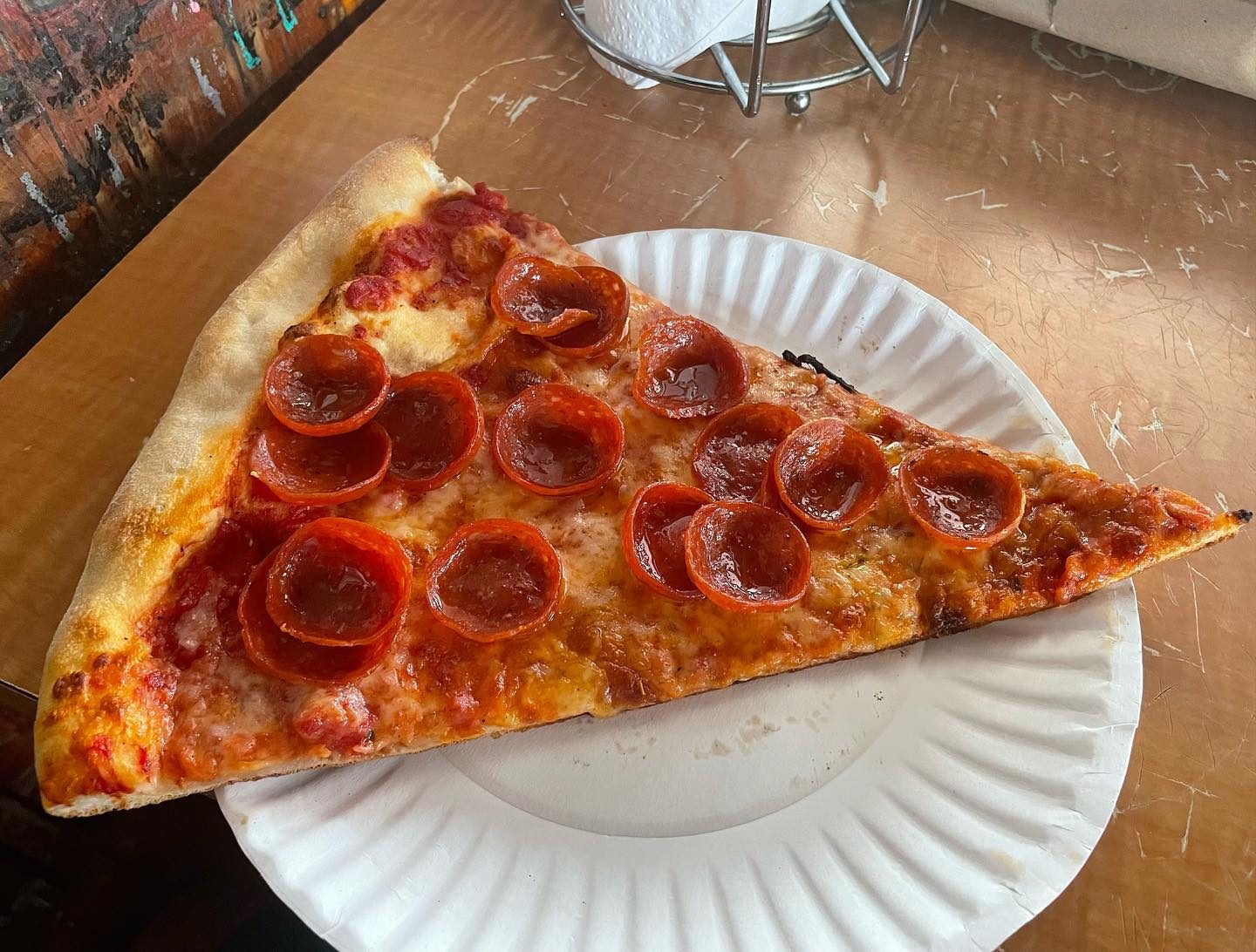 Pepperoni slice on a paper plate at Steve’s Pizza