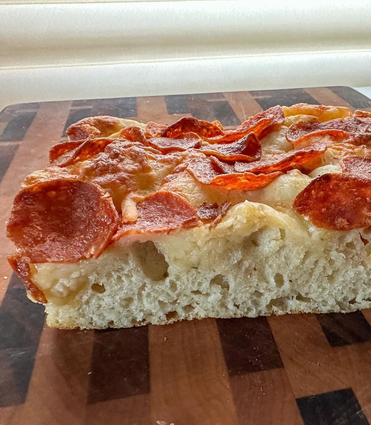 Close view of a pizza slice at The Wheel
