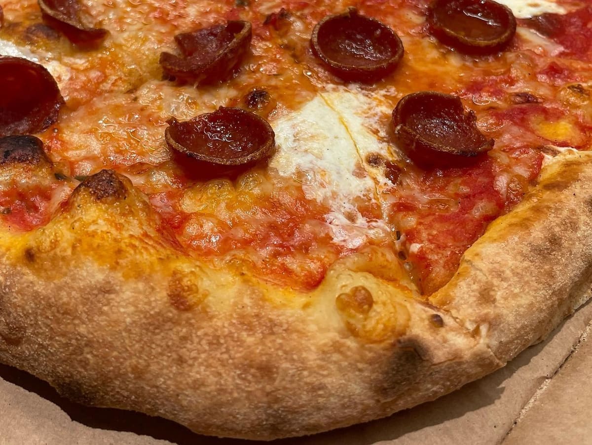 Close view of a pizza slice at Timber Pizza Co
