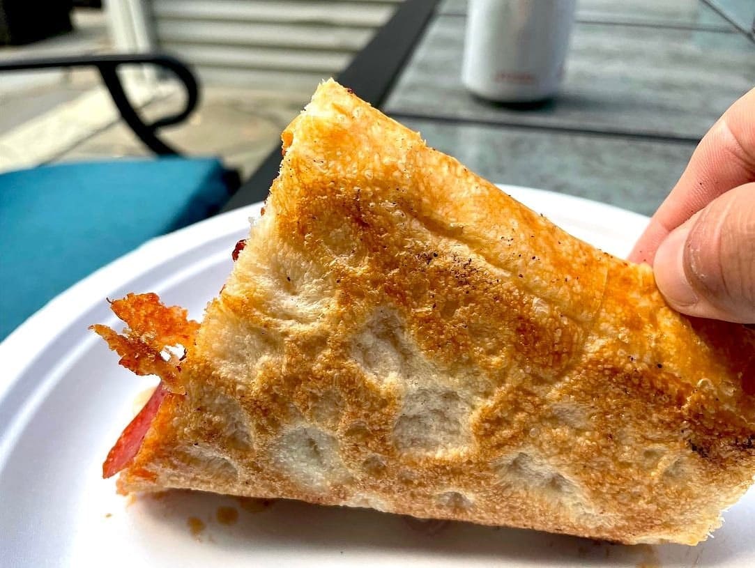 Underside of the pizza crust at Trotta’s Pizza