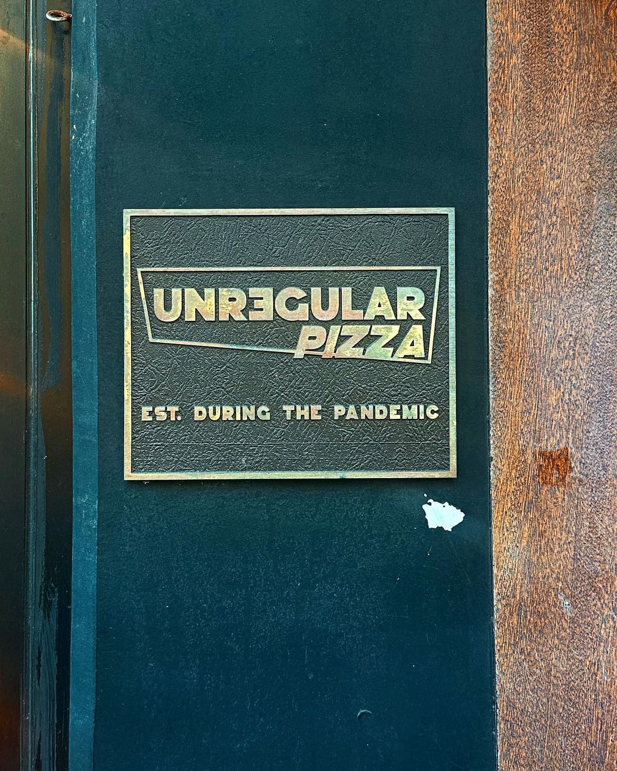 Restaurant sign at Unregular Pizza