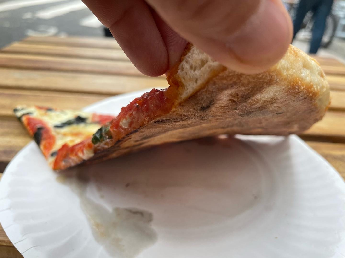 Slice folded to show the crust at Vito’s Slices & Ices