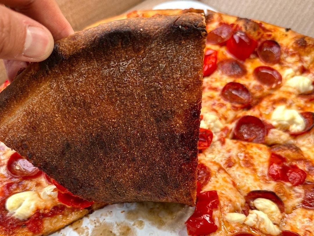 Underside of the pizza crust at Your Mom’s Pizzeria