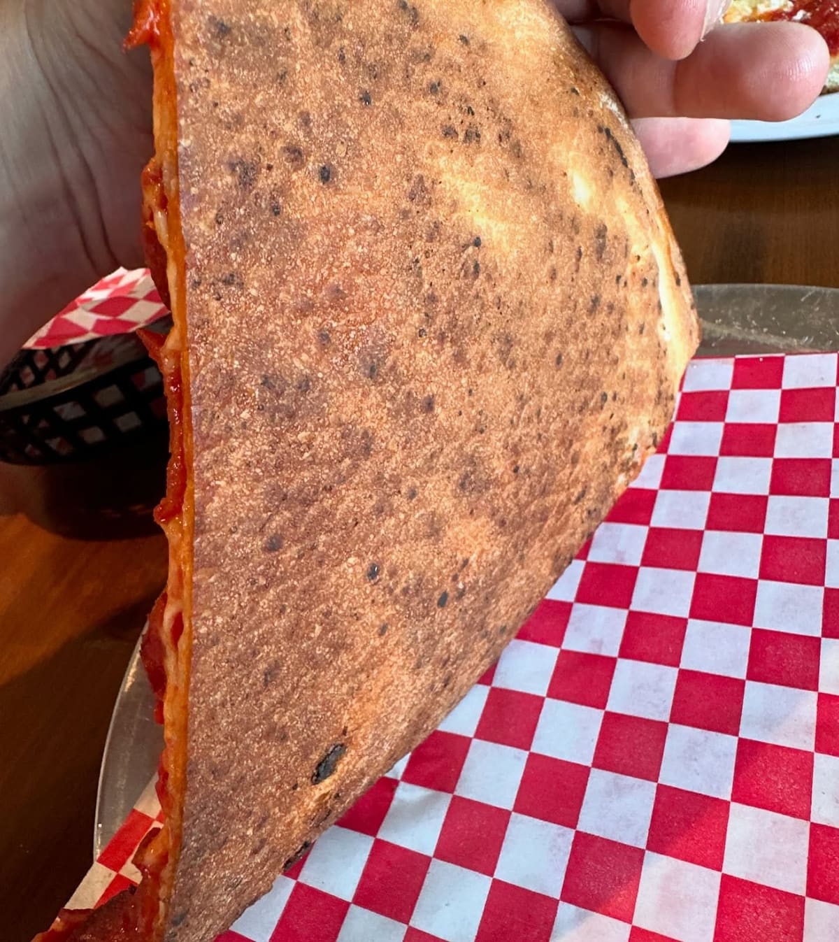 Underside of the pizza crust at Your Mom’s Pizzeria