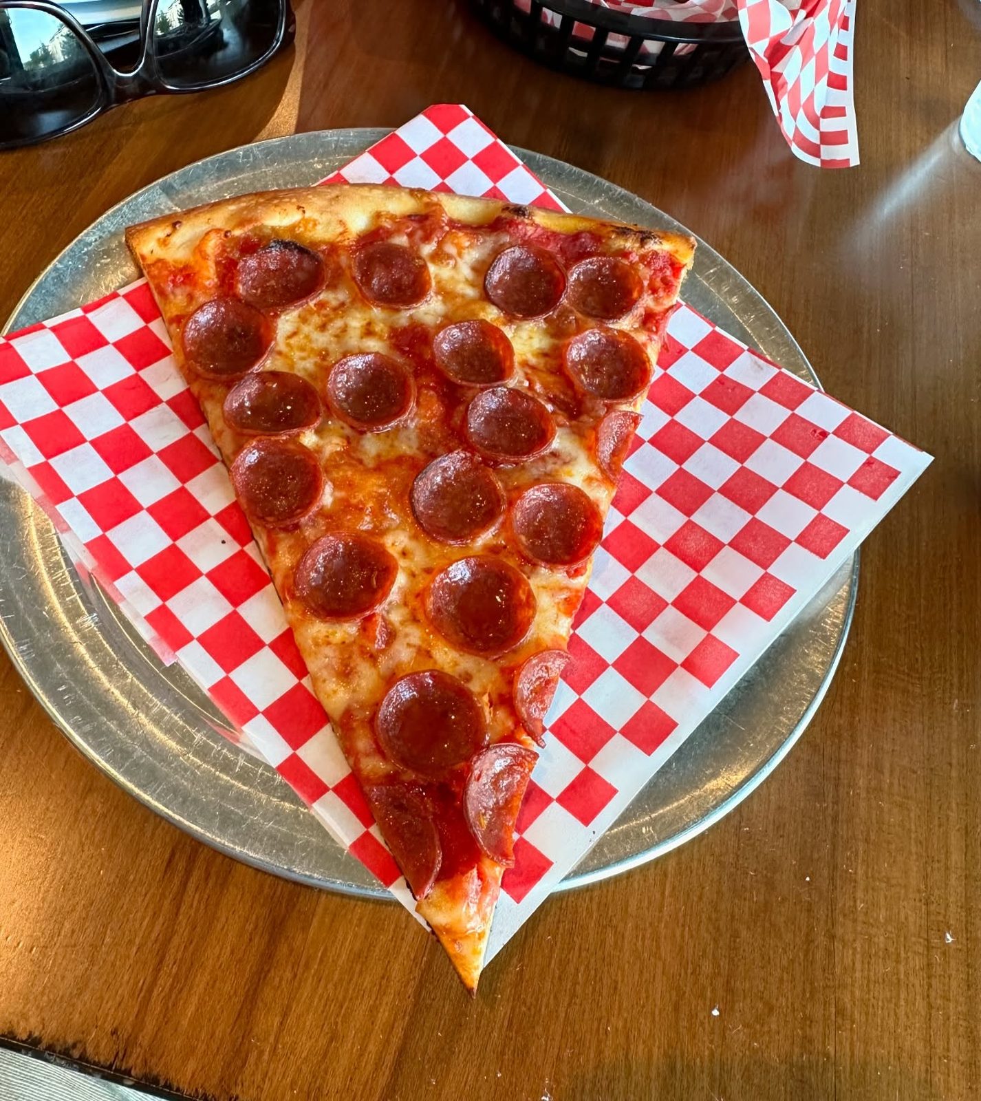 Pepperoni slice on a metal tray at Your Mom’s Pizzeria