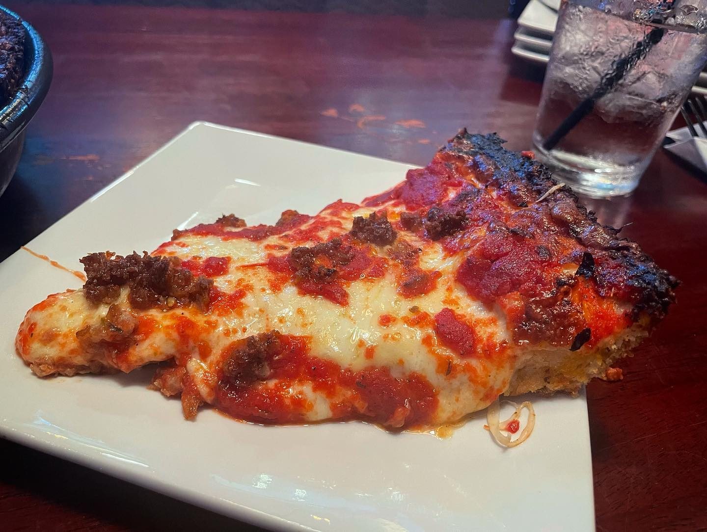 A slice on a plate at ZZA Baby Pizza Bar