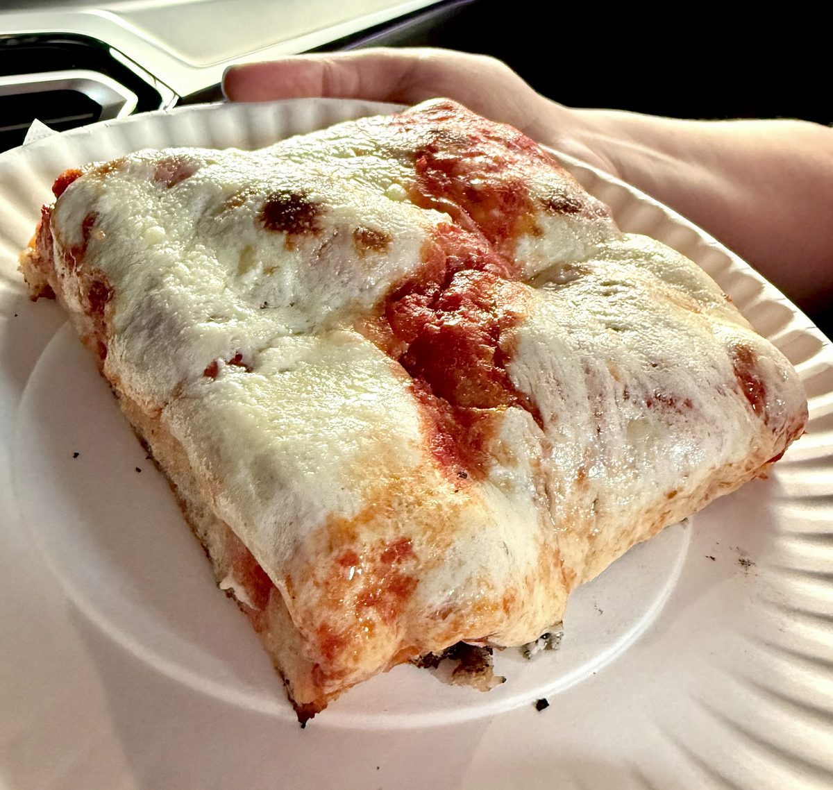 cheese-blanketed square slice held on a paper plate, Brooklyn Square Pizza