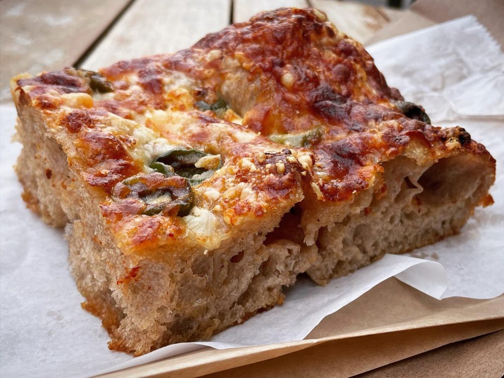 Thick airy focaccia crumb topped with pepper rings, Brown Bear Bakery
