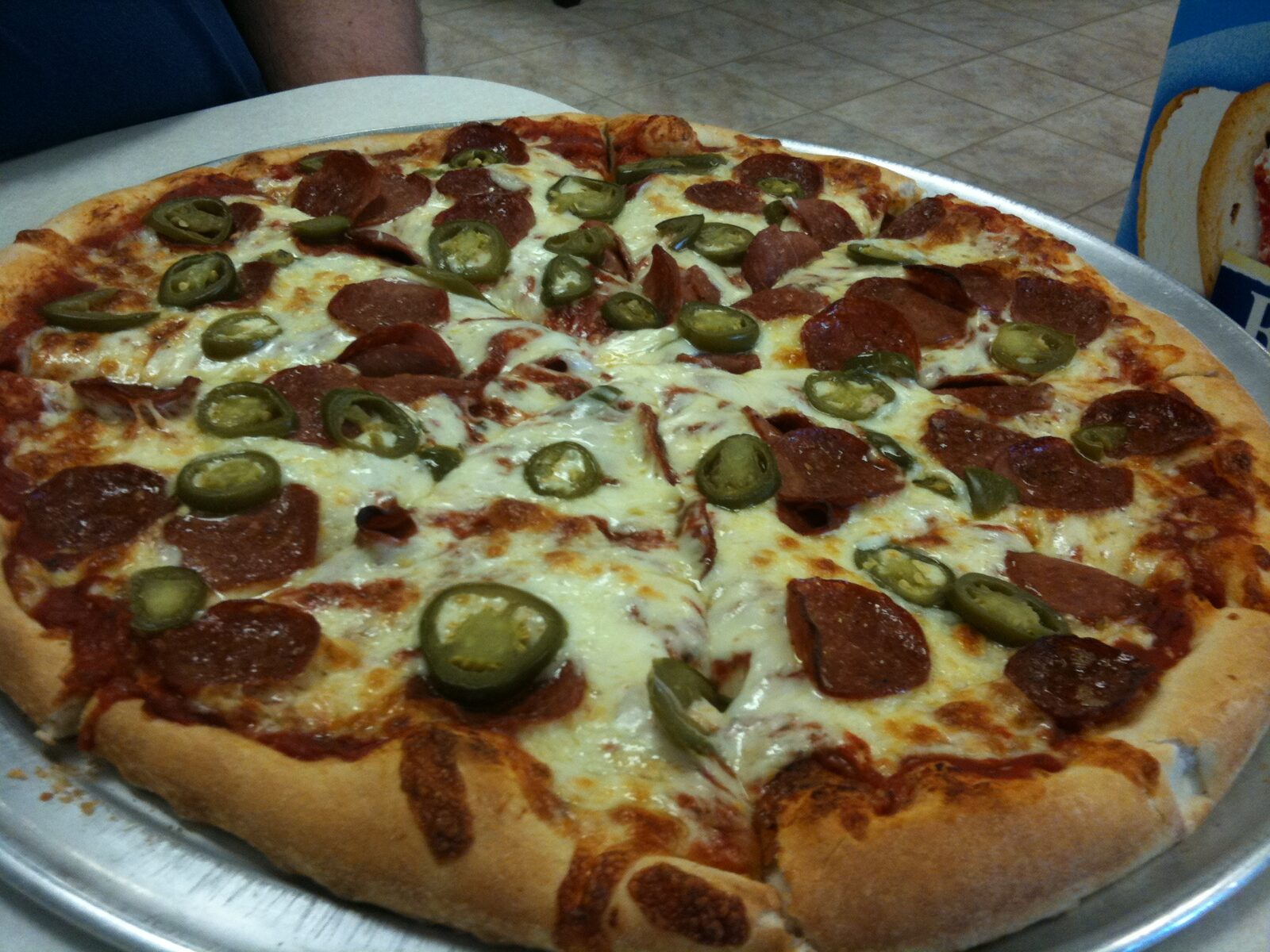 Pepperoni slice dusted with oregano and red pepper flakes, Flying Pizza