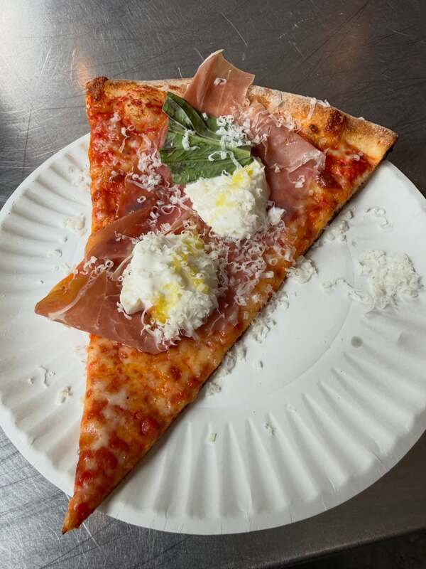 Folded prosciutto and burrata dollops over a basil leaf slice, L'Industrie Pizzeria