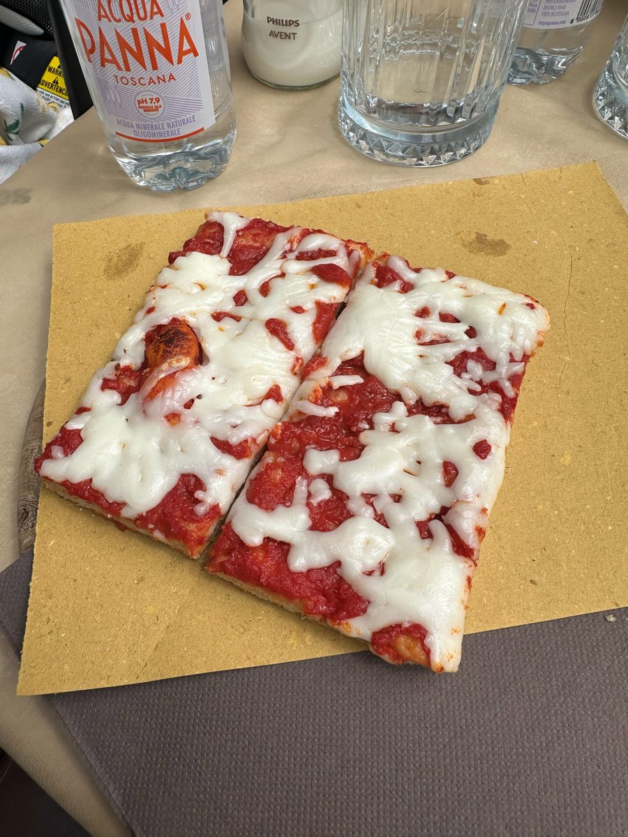 Rectangular al taglio slices with tomato and melted mozzarella on a paper board, Panificio Sclavi