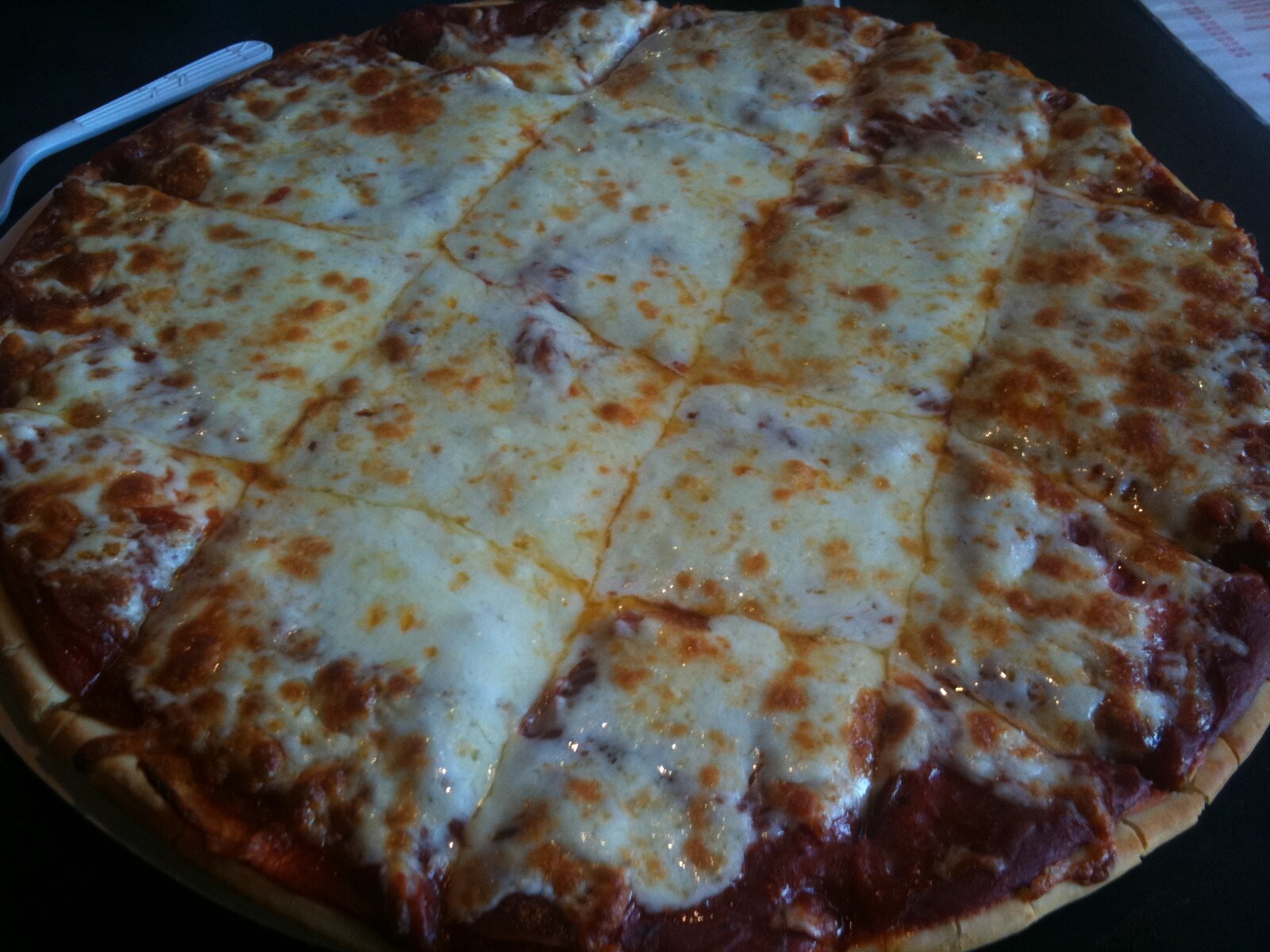 large-cut square pizza with a pale, doughy crust, Riverfront Pizza