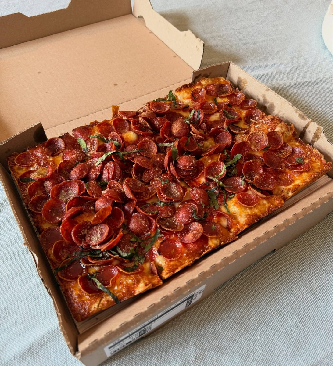 Thin cupped pepperoni blanketing a boxed Detroit square, Taglio
