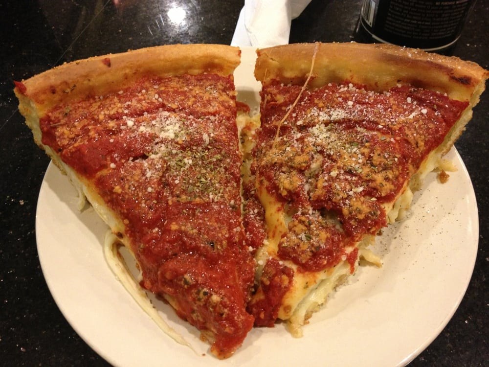 Cheese-pull deep dish slices under chunky herbed sauce, The Art of Pizza