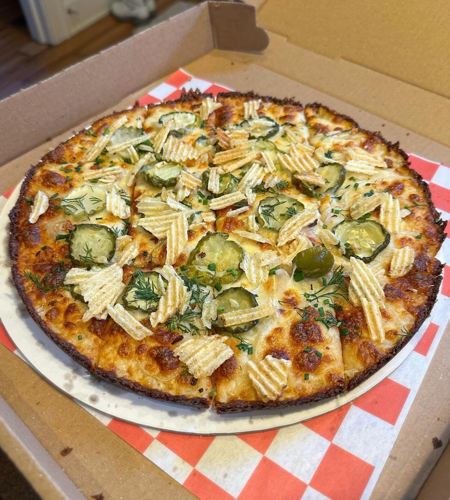 pickle and potato chip topped square slices in takeout box, Wayfarer