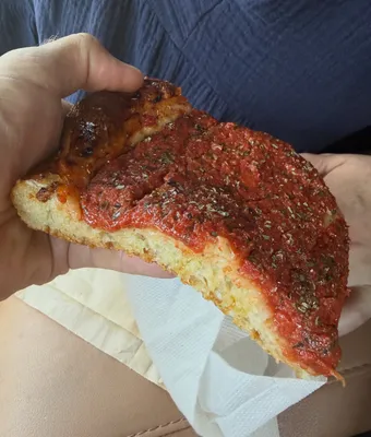 Holding a slice of tomato pie at Liberty Kitchen